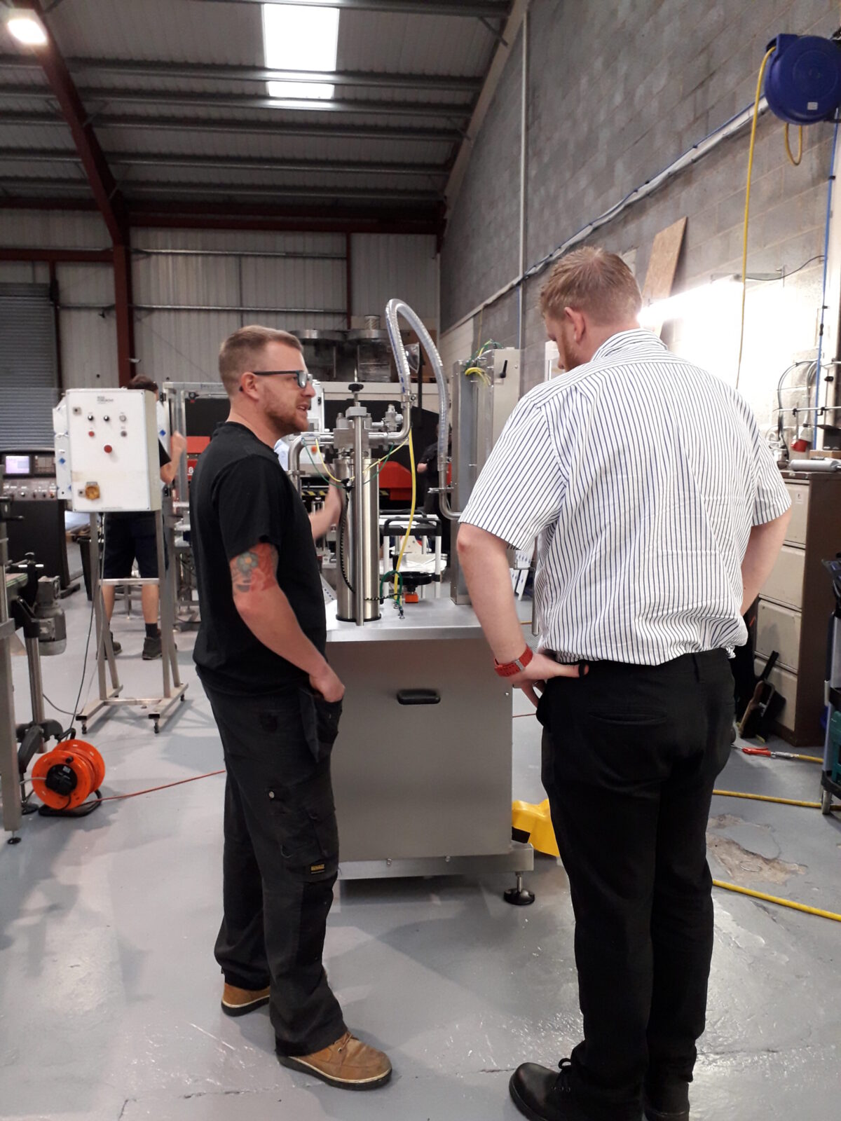 Simon shows design engineer Matthew one of our new semi-automatic fillers.