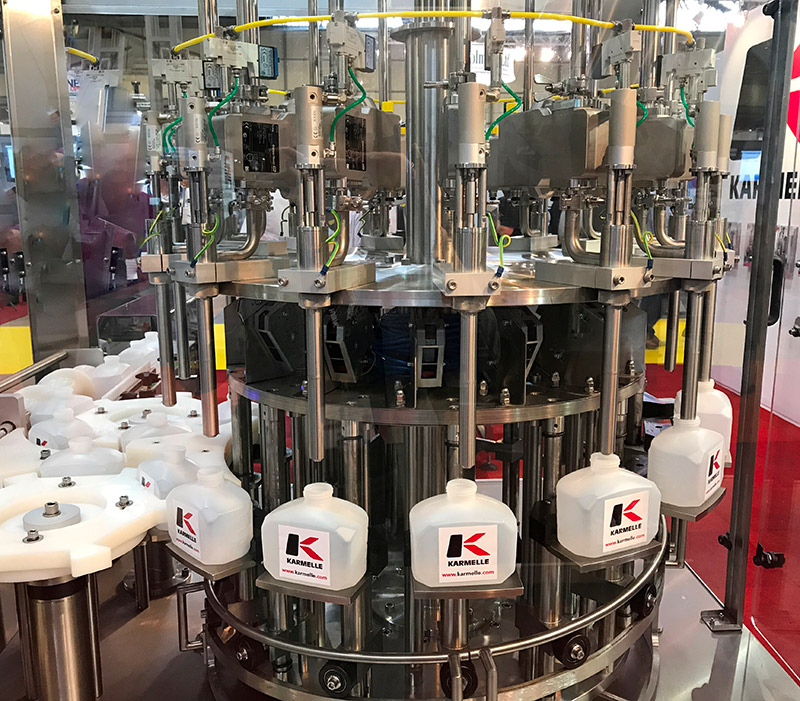 A Karmelle Inline Rotary Filling Machine with multiple heads.