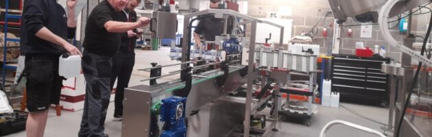 Engineers run a labelling machine